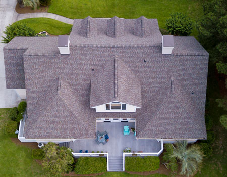 The top-down view of a house with a newly installed shingle roof.
